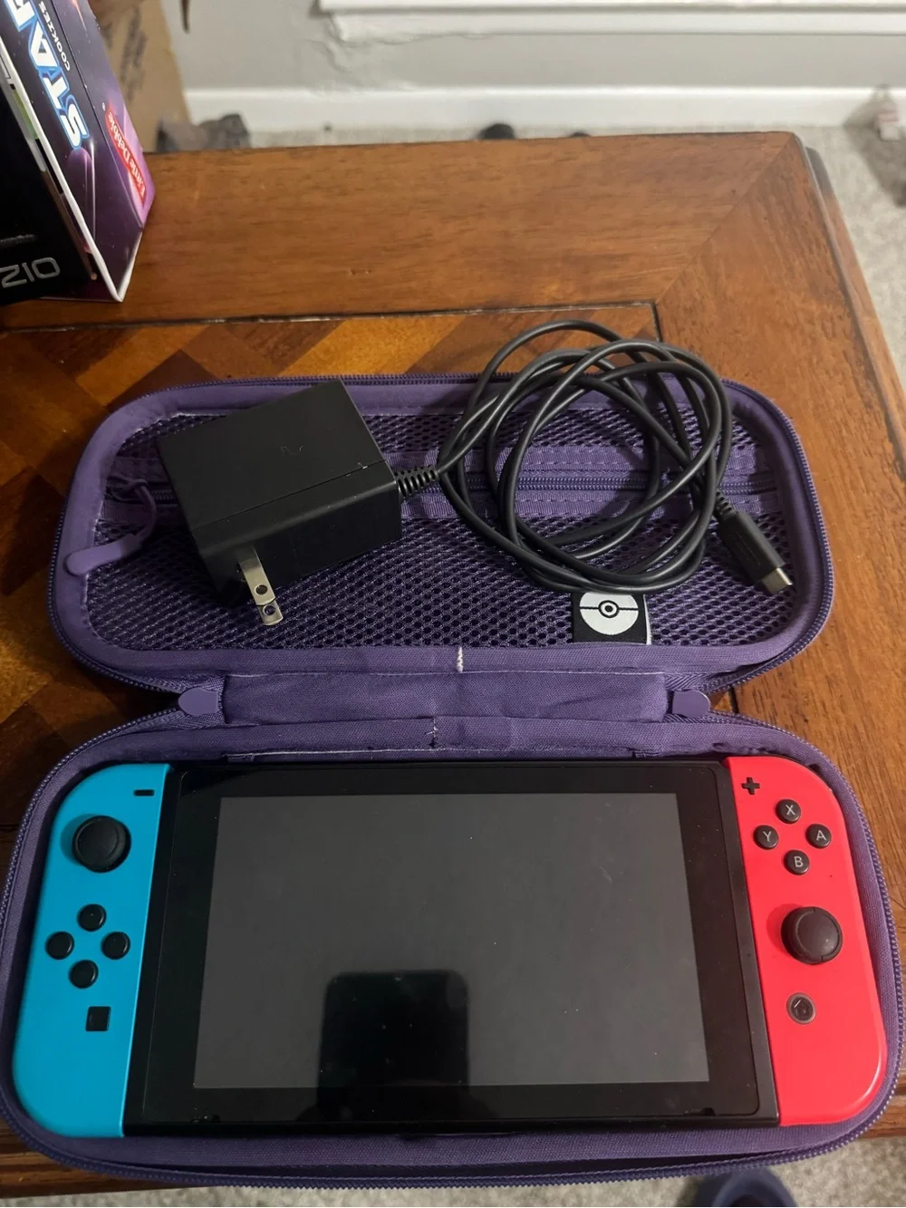Nintendo Switch with Blue Left & Red Right Joy-Con and Purple Carry Case